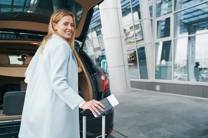 Traveler with luggage at an airport terminal — Chicago airport transfers