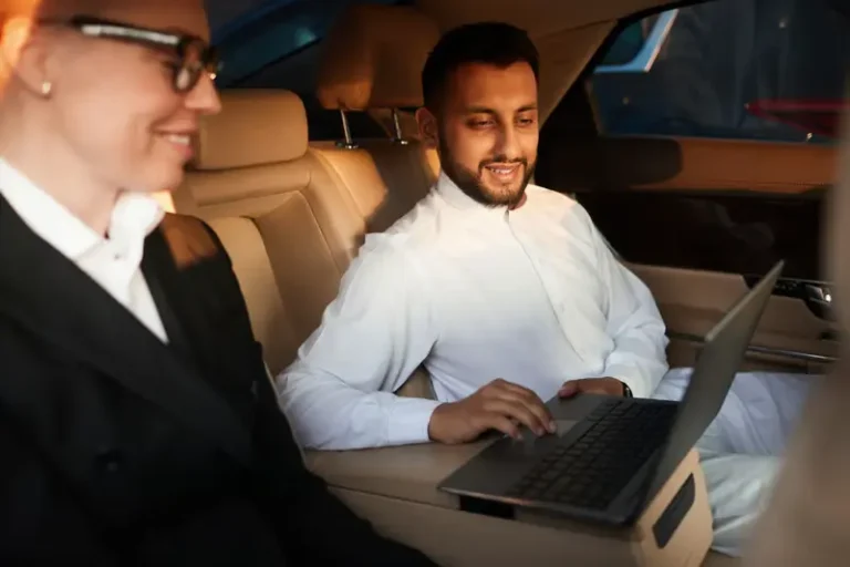 Executive working on a laptop in the back seat — Chicago corporate car service