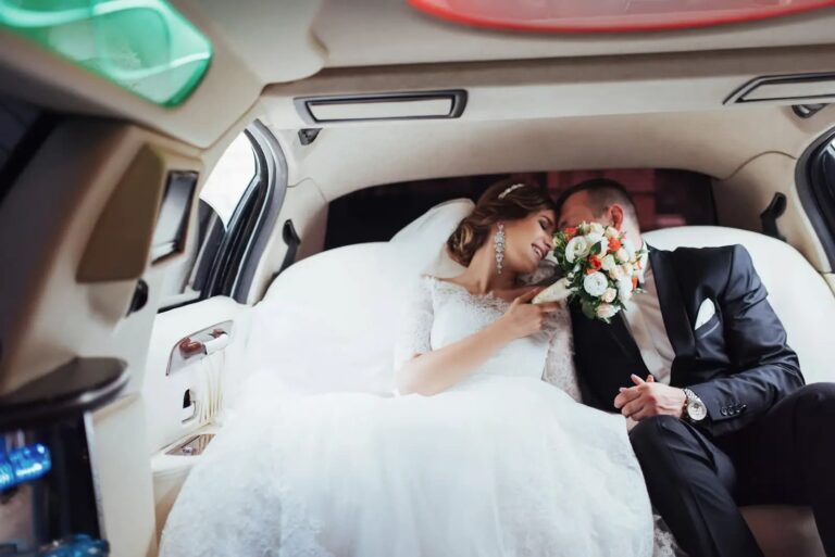 Bride and groom in a limousine with bouquet — Chicago wedding transportation
